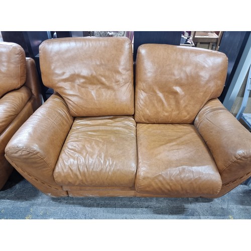 657 - Star lot : A pair of very comfortable two seater leather sofas, with a wonderful curved frame and up... 