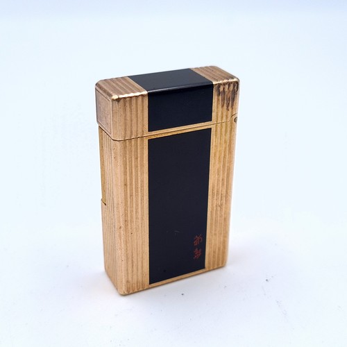 501 - A handsome example of a heavy vintage singed DuPoint of Paris gold coloured metal gas lighter, featu... 