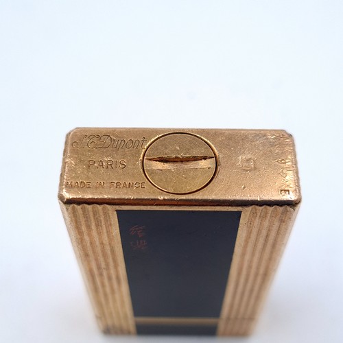 501 - A handsome example of a heavy vintage singed DuPoint of Paris gold coloured metal gas lighter, featu... 