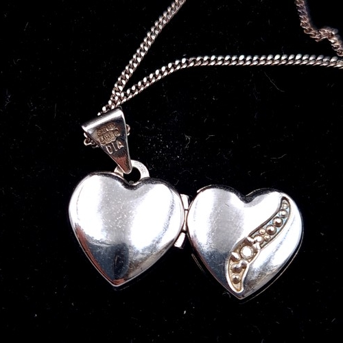 517 - A sterling silver necklace, set nicely with a pretty twin heart pendant locket. Length of chain: 44c... 