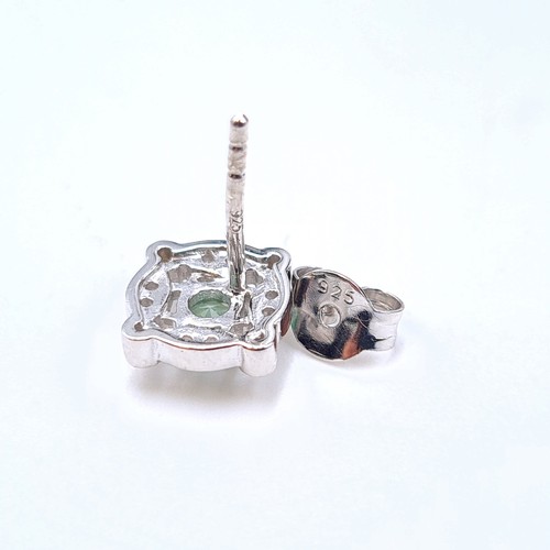 536 - A fine pair of sterling silver Green Spinel stone stud earrings, set with a lovely gem stone surroun... 