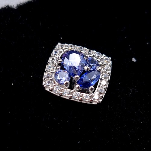 539 - A sparkling pair of sterling silver Tanzanite stone stud earrings, set with beautiful White Sapphire... 