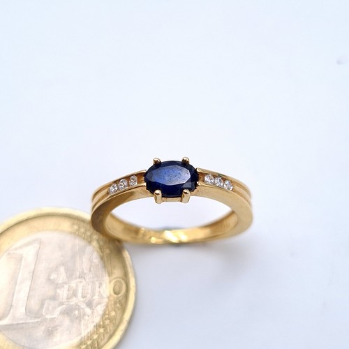 545 - Star lot : A super example of a 9 carat gold Deep Blue Sapphire and Diamond stone ring, set with a w... 