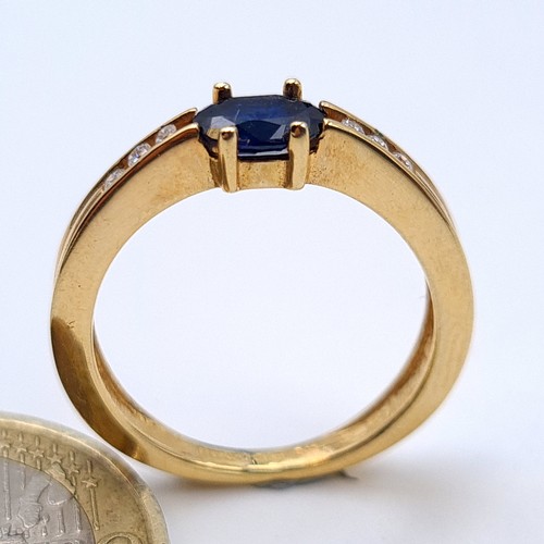 545 - Star lot : A super example of a 9 carat gold Deep Blue Sapphire and Diamond stone ring, set with a w... 