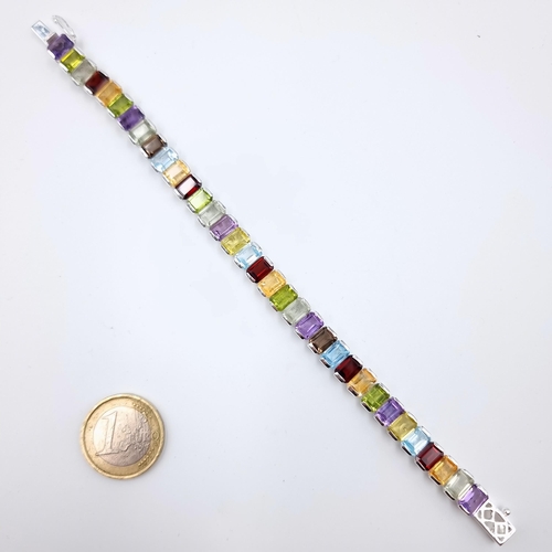 1 - Star Lot : A fabulous example of a sterling silver set multi-gem stone tennis bracelet, consisting o... 