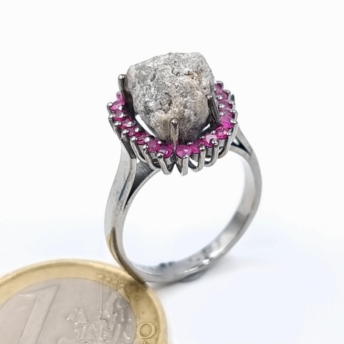 10 - An unusual natural Grey rough Diamond ring, of 6 carats and featuring a Ruby stone surround. Mounted... 