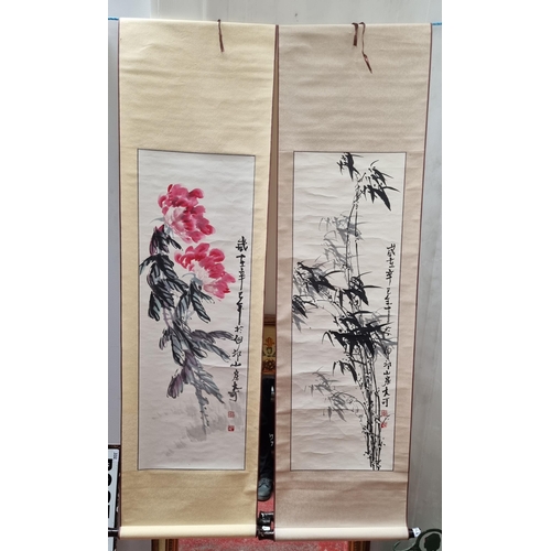 114 - A pair of handpainted Chinese ink on paper wall scroll hangings illustrated with large floral and fo... 