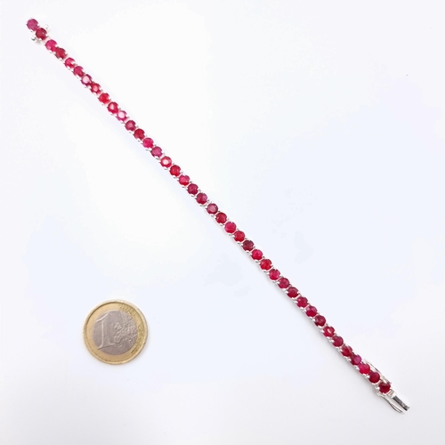 16 - A fine example of a Ruby stone sterling silver tennis bracelet, of a generous 10 carats. Each Ruby s... 