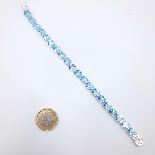 2 - Star Lot : A very attractive sterling silver tennis bracelet, consisting of natural Blue Topaz gem s... 