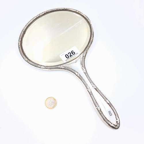 26 - An attractive example of a vintage sterling silver oval hand mirror, set with a nice line surround. ... 