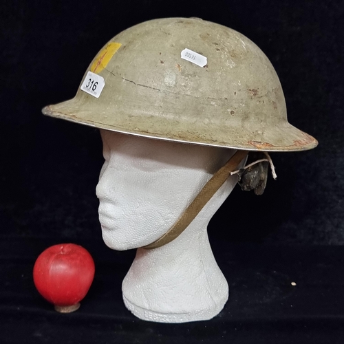 An Emergency Period WWII Irish Army Helmet with the badge of