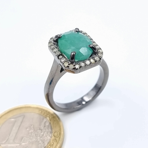 5 - Star Lot : A striking Emerald and Diamond ring, featuring a centre .35 carats Emerald and surrounded... 