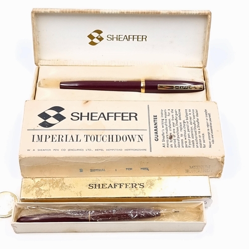 55 - A Sheaffer Imperial touch down fountain pen, set with dark resin body and gold metal detailing. In o... 