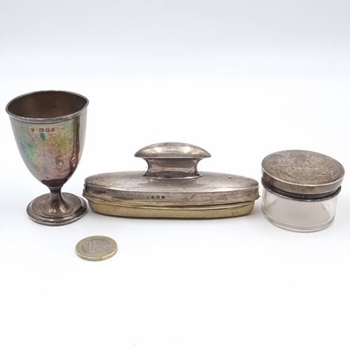 57 - A collection of three silver items, including an antique egg cup which is hallmarked London (height:... 