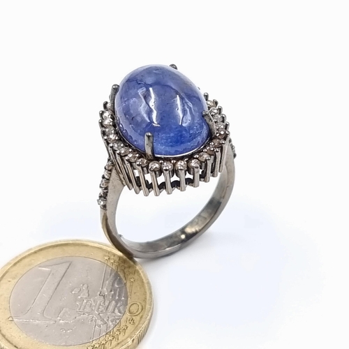 9 - Star Lot : An exquisite cabochon Tanzanite and Diamond ring, featuring a generously large 12.3 carat... 