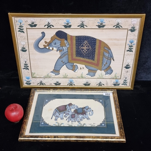 92 - Two Arabian paintings on silk featuring highly ornate elephants dressed in elaborate tapestries with... 