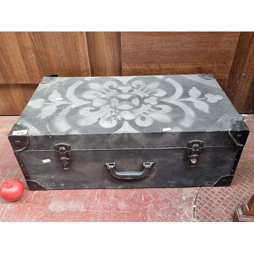 A charming vintage style trunk wrapped in a linen upholstery. Designed in shades of black and silver with a harlequin style diamond stencil. Has been upcycled. H26cm x W70cm x D38cm
