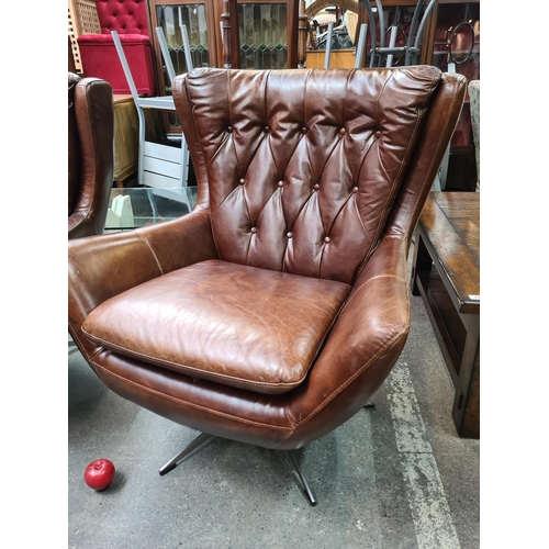 890 - Star Lot : A gorgeous example of a genuine leather wing back swivel chair by Wells Leather. Designed... 