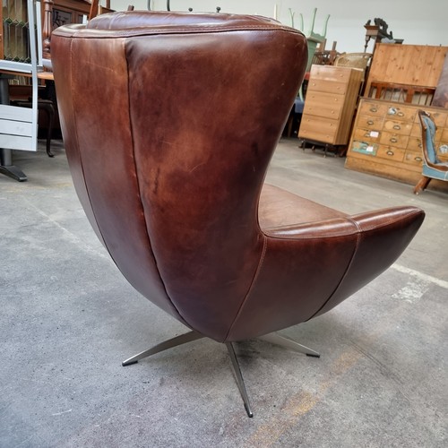 890 - Star Lot : A gorgeous example of a genuine leather wing back swivel chair by Wells Leather. Designed... 