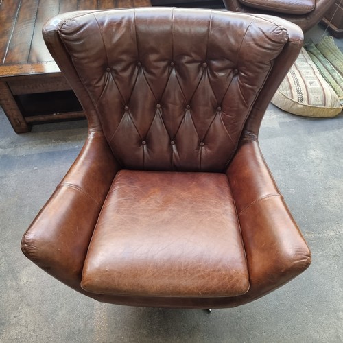 890 - Star Lot : A gorgeous example of a genuine leather wing back swivel chair by Wells Leather. Designed... 