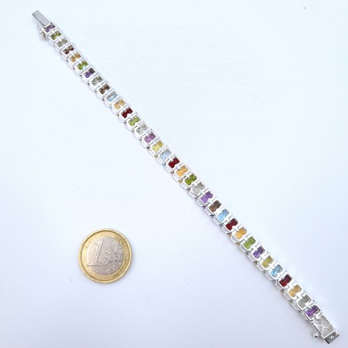 1 - Star Lot : A fabulous example of a sterling silver set multi-gem stone tennis bracelet, consisting o... 