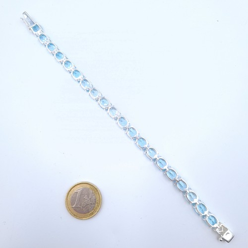 2 - Star Lot : A very attractive sterling silver tennis bracelet, consisting of natural Blue Topaz gem s... 