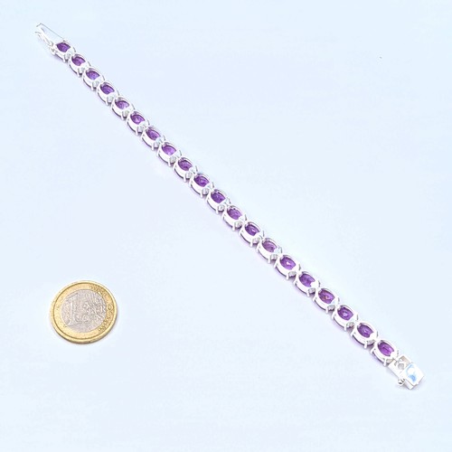 3 - Star Lot : A fine example of a sterling silver Amethyst stone tennis bracelet, featuring a fabulous ... 