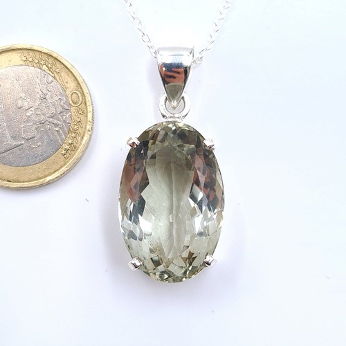 12 - A very pretty oval cut Amethyst stone pendant necklace, set in sterling silver. Length of chain: 40c... 