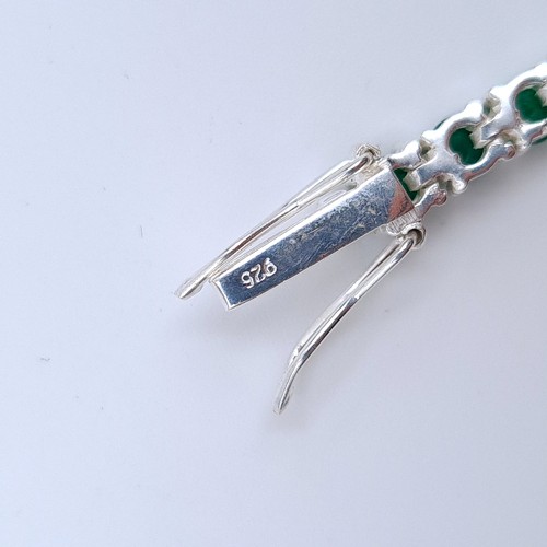 15 - An fine example of an Emerald 10 carat sterling silver tennis bracelet, each measuring 3 millimetre.... 