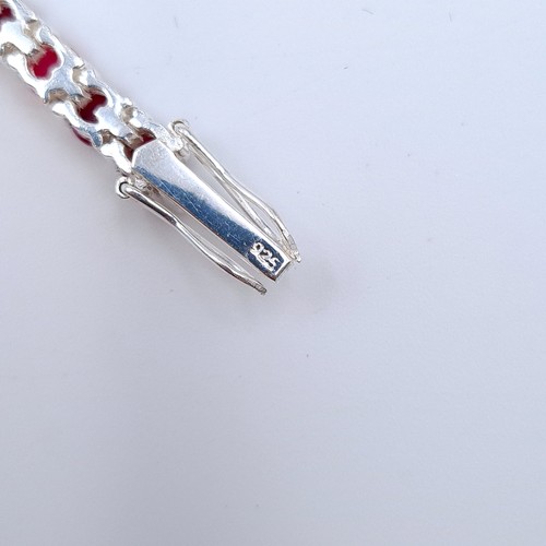 16 - A fine example of a Ruby stone sterling silver tennis bracelet, of a generous 10 carats. Each Ruby s... 