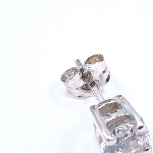 22 - An attractive pair of 9 carat white gold stud earrings, featuring sparkling bright Zircon stones. En... 
