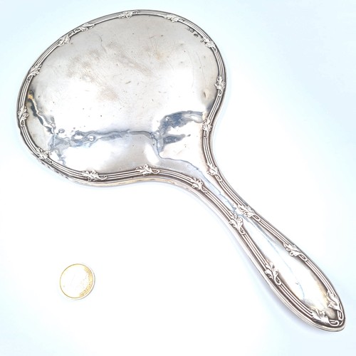 26 - An attractive example of a vintage sterling silver oval hand mirror, set with a nice line surround. ... 