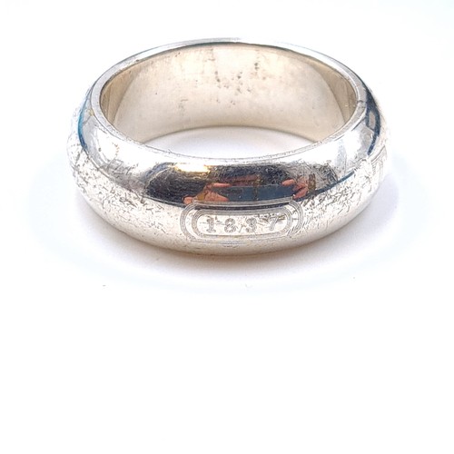 25 - A collection of high quality sterling silver items, consisting of a Tiffany & Co wide band heavy gau... 