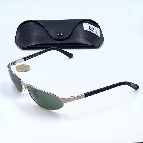 31 - A pair of designer wrap around Ray-Ban sunglasses. Fully marked and set with sterling silver mount. ... 