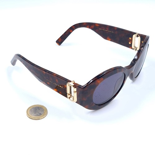 47 - A pair of designer Marc Jacobs sunglasses, set with Faux Tortoiseshell frames. and featuring a styli... 