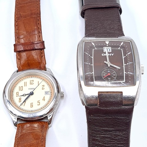 48 - A collection of four wrist watches, in an array of styles and designs. This includes two Fossil exam... 