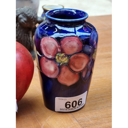 606 - A highly collectable Moorcroft pottery bud vase with the clematis pattern circa 1930. Similar by the... 