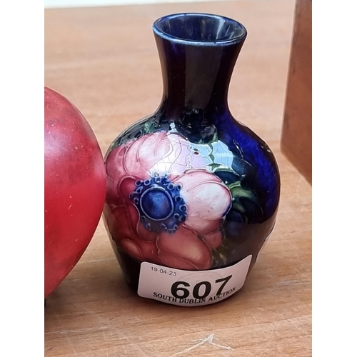 607 - A highly collectable Moorcroft pottery bud vase with the Anemone pattern. Featuring large pink bloom... 