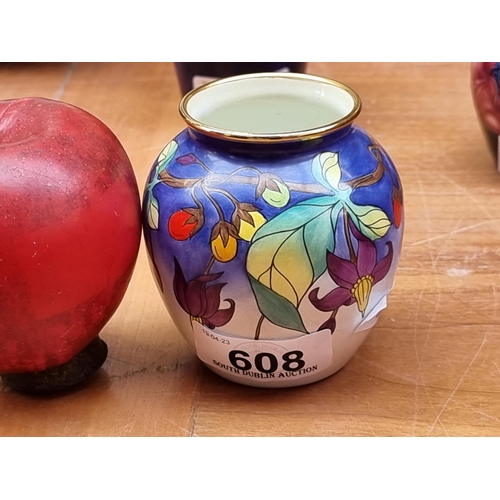 608 - A pair of highly collectable painted enamel Moorcroft vases in the Bittersweet design by Emma Bosson... 