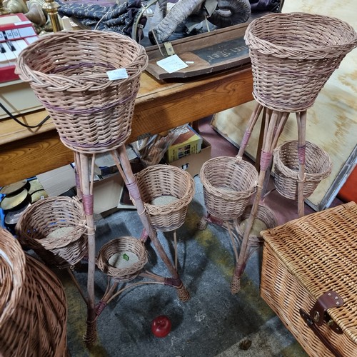 929 - Two woven wicker plant stands with four planters each in a tiered quadruped setting. These are New  ... 