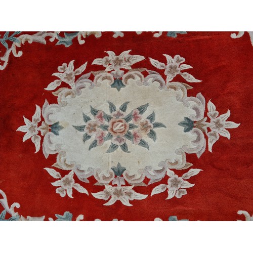 982 - A large thick pile vintage Chinese floor rug. Featuring as soft floral display in pastels with a str... 