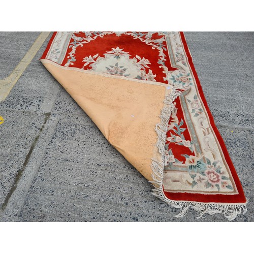 982 - A large thick pile vintage Chinese floor rug. Featuring as soft floral display in pastels with a str... 