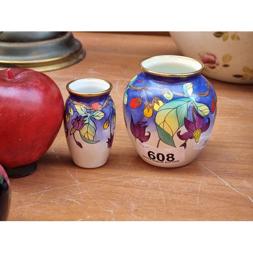 608 - A pair of highly collectable painted enamel Moorcroft vases in the Bittersweet design by Emma Bosson... 