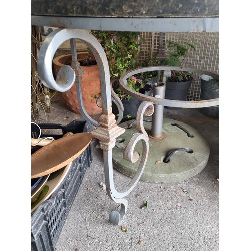 983 - Star Lot : A very heavy black marble garden table with a wrought metal base in a grey finish. With l... 