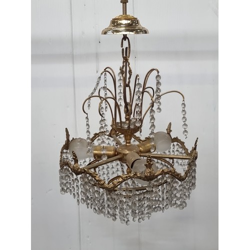 991 - A beautiful chandelier with a brass toned frame featuring foliate detail and beaded droplets. A matc... 