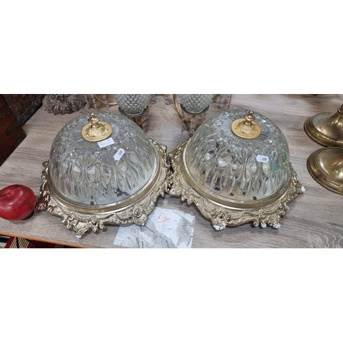 992 - Two fabulous dome ceiling lights with a brass toned mount boasting delicate foliate motifs and holdi... 