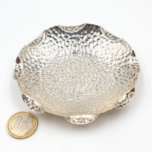 12 - An unusual large and heavy hammered Irish silver pin dish, featuring an exaggerated scalloped edge. ... 