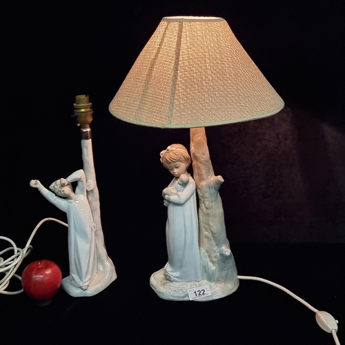 122 - Two Spanish porcelain table lamps including a Nao by Lladro example featuring a yawning young boy in... 