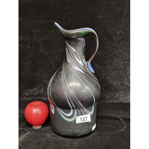 127 - Star Lot : A fantastic ceramic pitcher in a dark glaze with a bright blue glazed interior that is pu... 