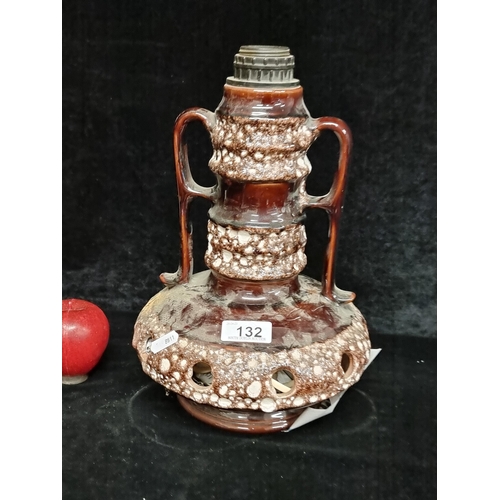 132 - An interesting Mid century ceramic table lamp with pierced detailing to base. Features a long neck w... 